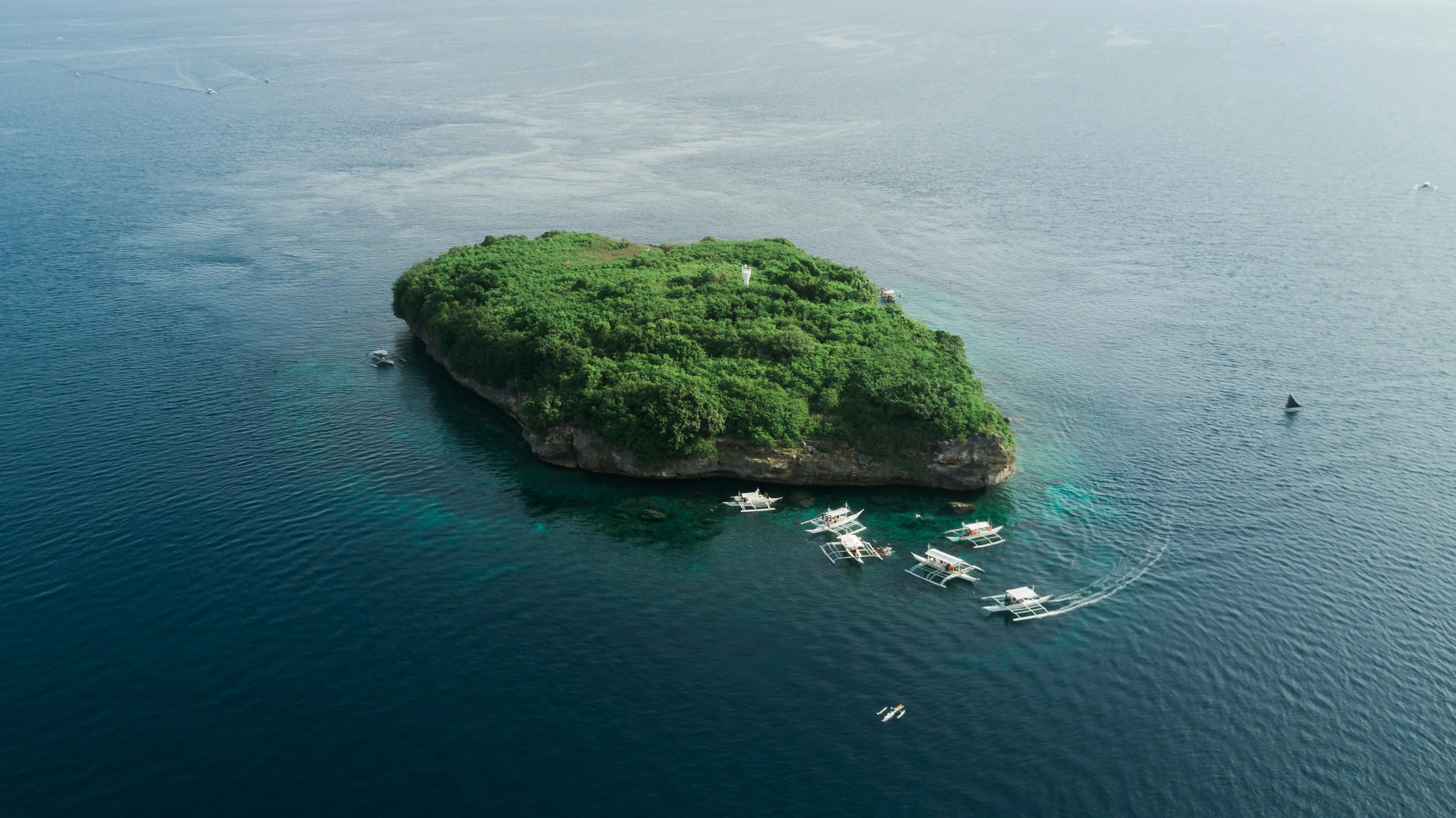 Pescador Island aerial view with crystal clear waters